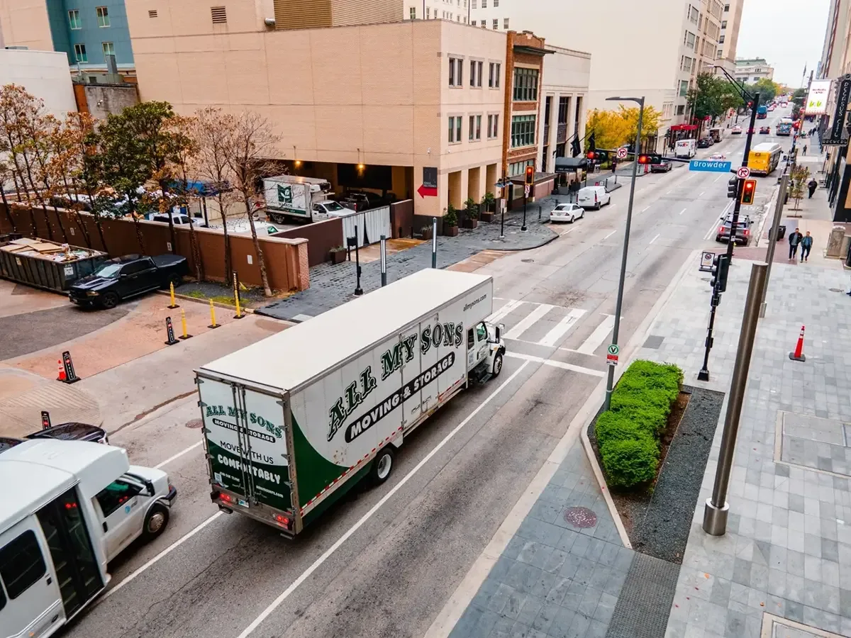 All My Sons moving truck navigates city streets.