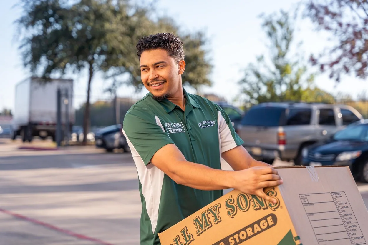 Professional movers from All My Sons take small kitchen appliances to the moving truck.