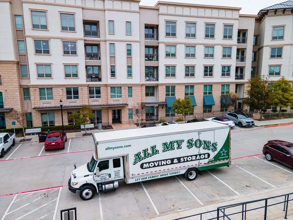 All My Sons moving truck parks out front of an apartment complex ready to move in.