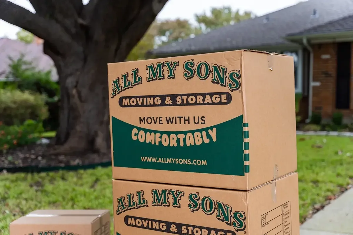 All My Sons moving boxes stacked on the sidewalk ready to be loaded into the moving truck.