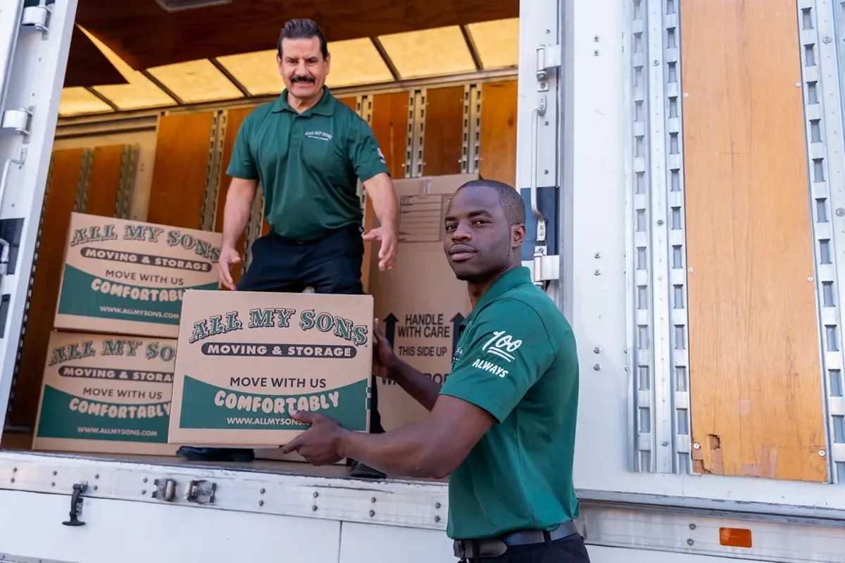 All My Sons team members load boxes into a moving truck.