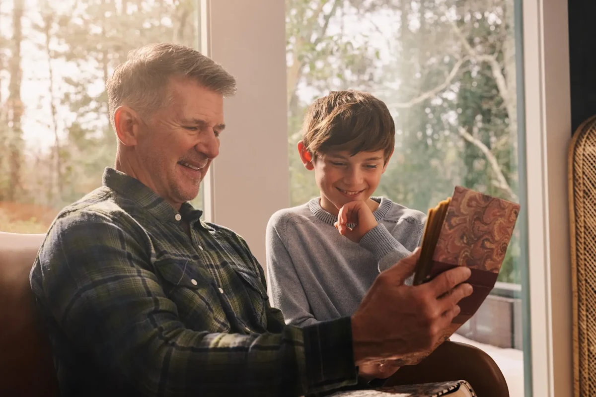 Grandfather and grandson look at old memories together prior to a move.