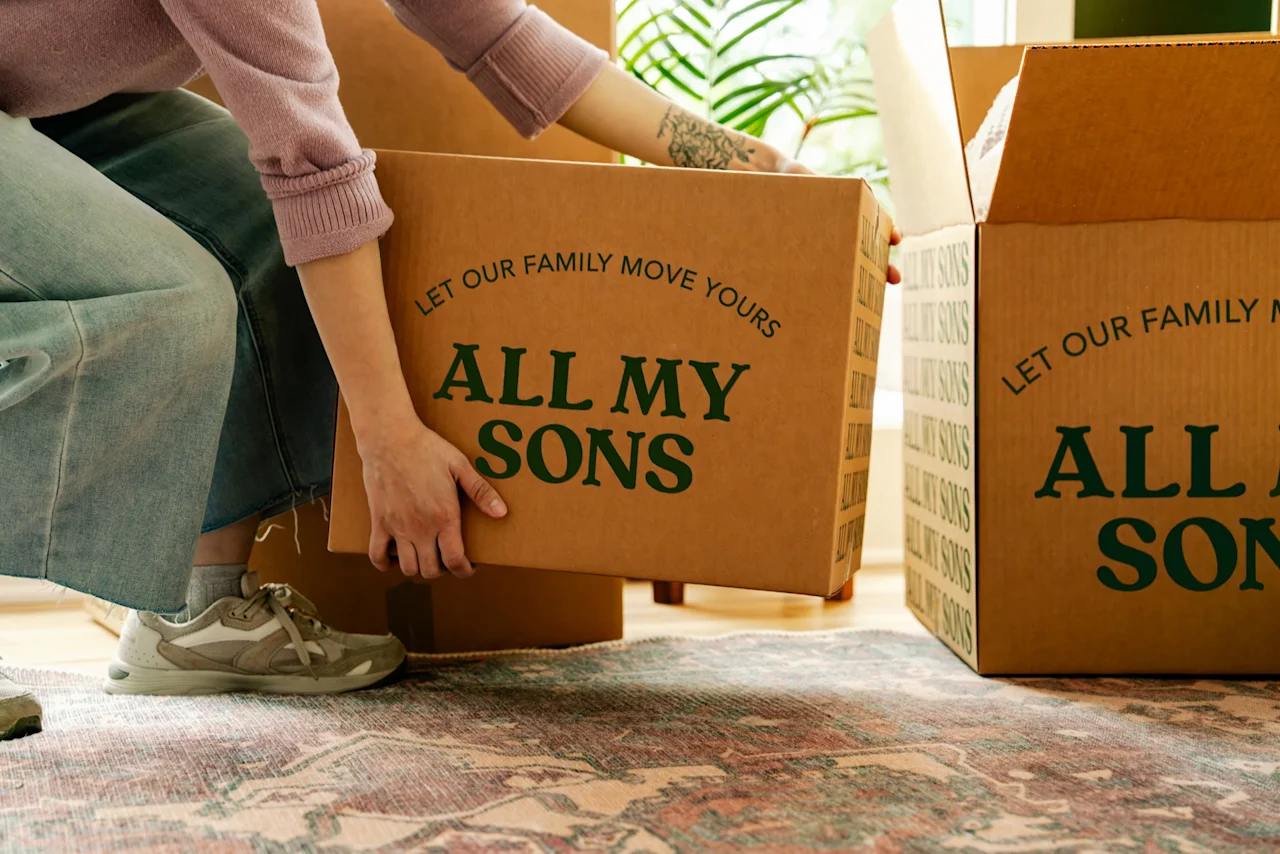 A college student takes All My Sons moving boxes to storage. 
