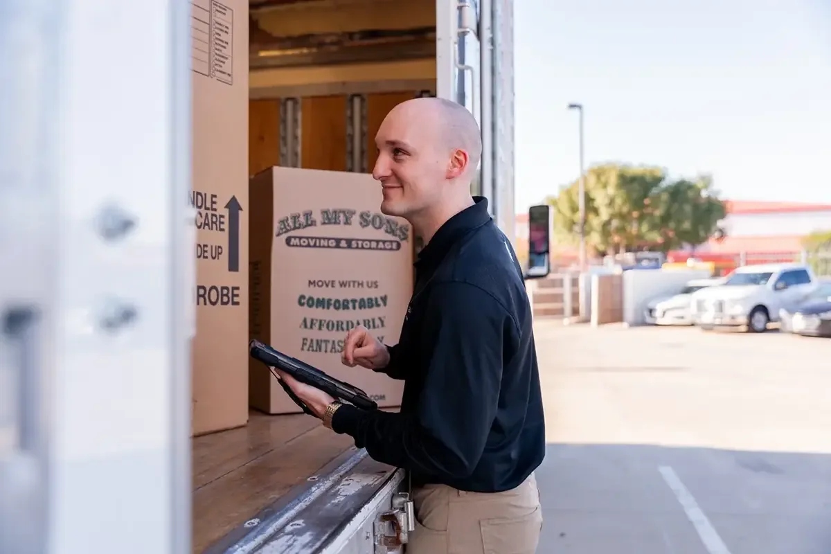 All My Sons team member checks the boxes in the back of a moving truck.
