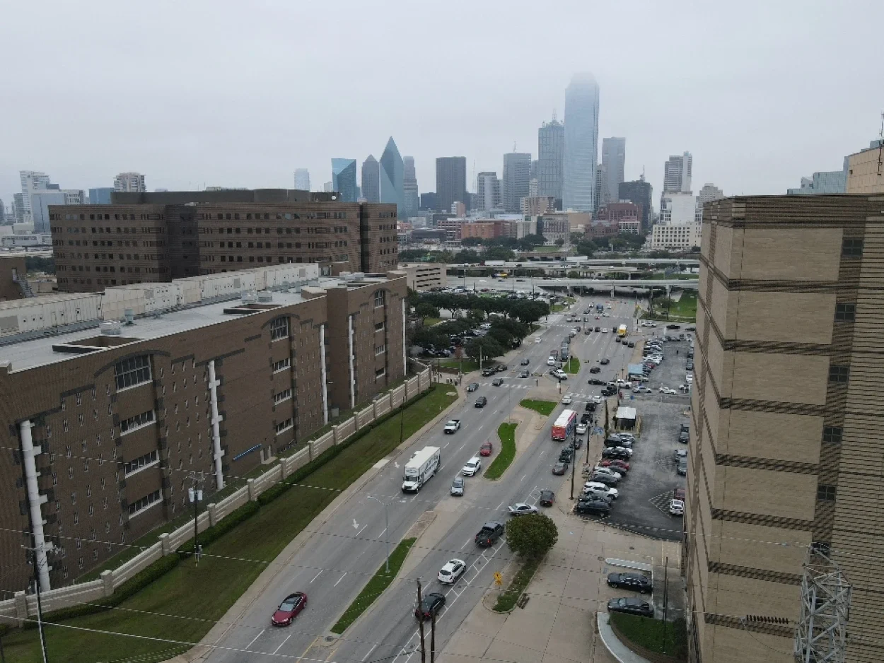 The Dallas, TX skyline featuring an All My Sons Moving Truck on a move.