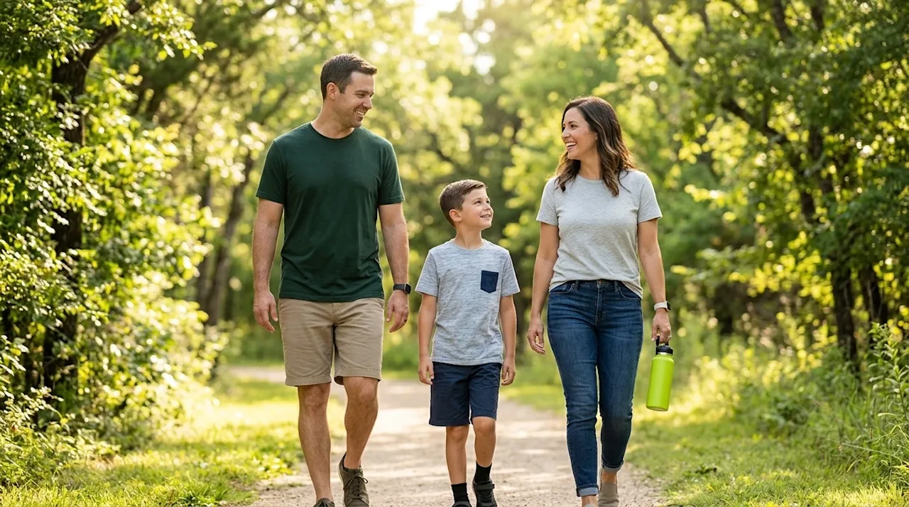 Professional lifestyle marketing photography of a happy, relaxed family enjoying a sunny afternoon walking along a lush, scen