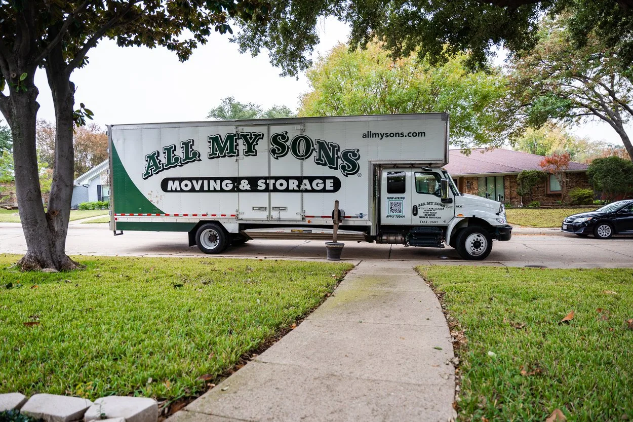 An All My Sons moving truck arrives in a suburban neighborhood to perform a move.