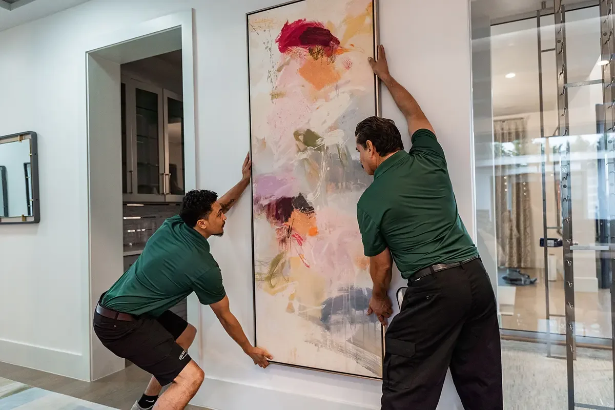 Professional movers from All My Sons Moving and Storage prepare to transport a delicate painting.