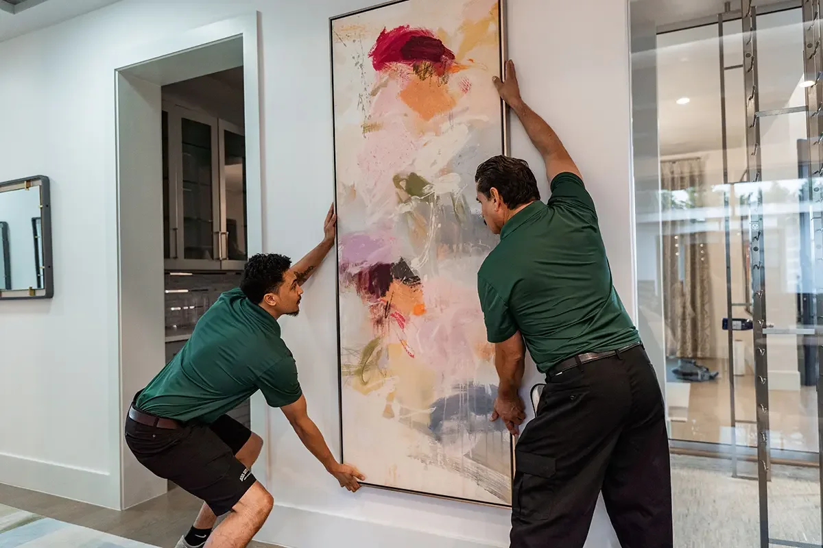 Professional movers from All My Sons Moving and Storage prepare to transport a delicate painting.