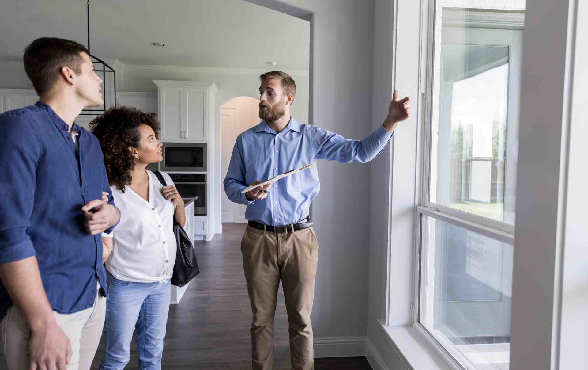 Man showing apartment to couple