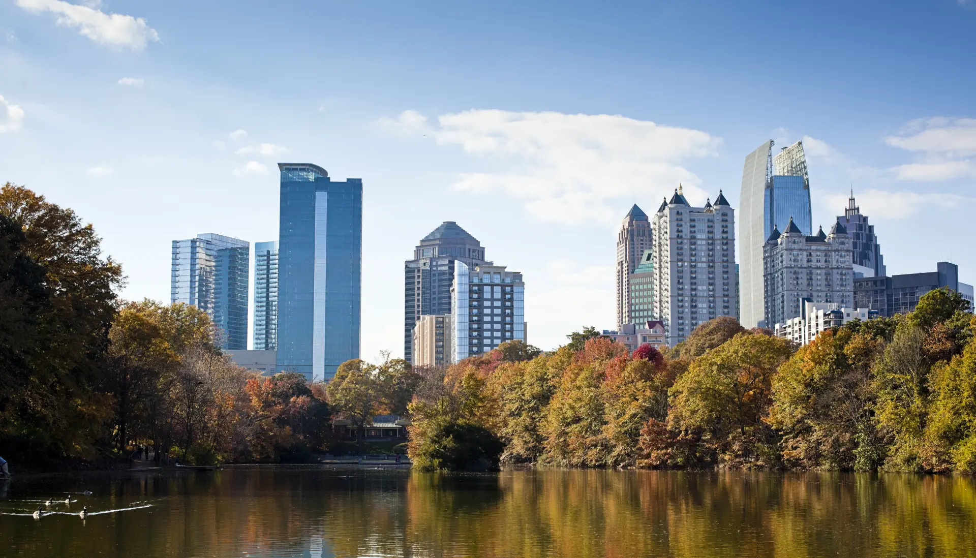 View of the Atlanta skyline from the river with fall foliage 