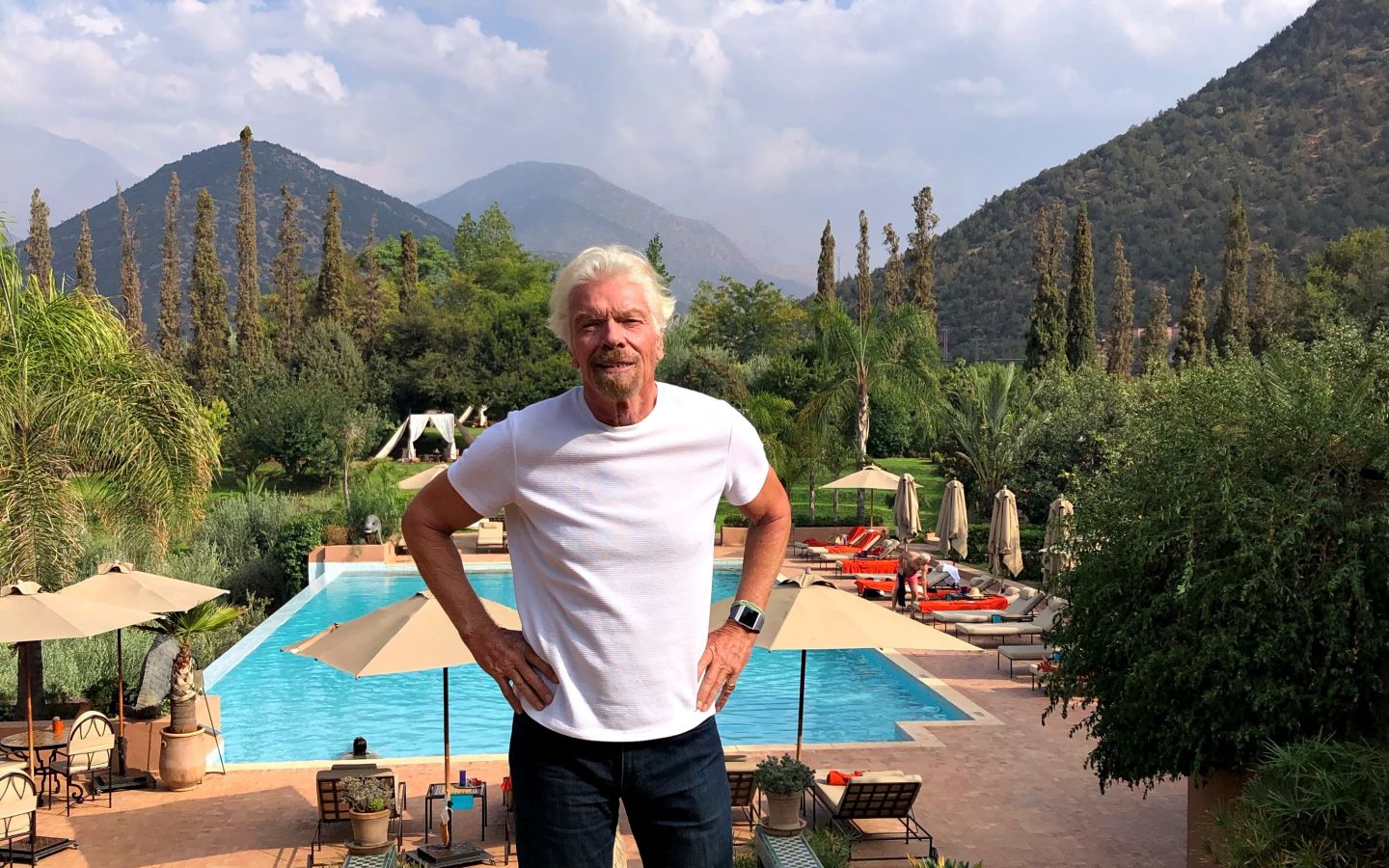 Richard Branson smiling in front of the pool at Kasbah Tamadot