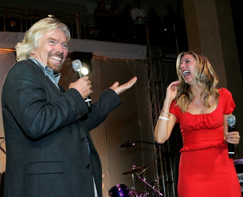 Richard Branson laughing with Sara Blakely
