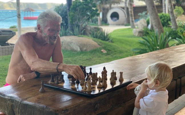 Richard Branson playing chess with his grandchild