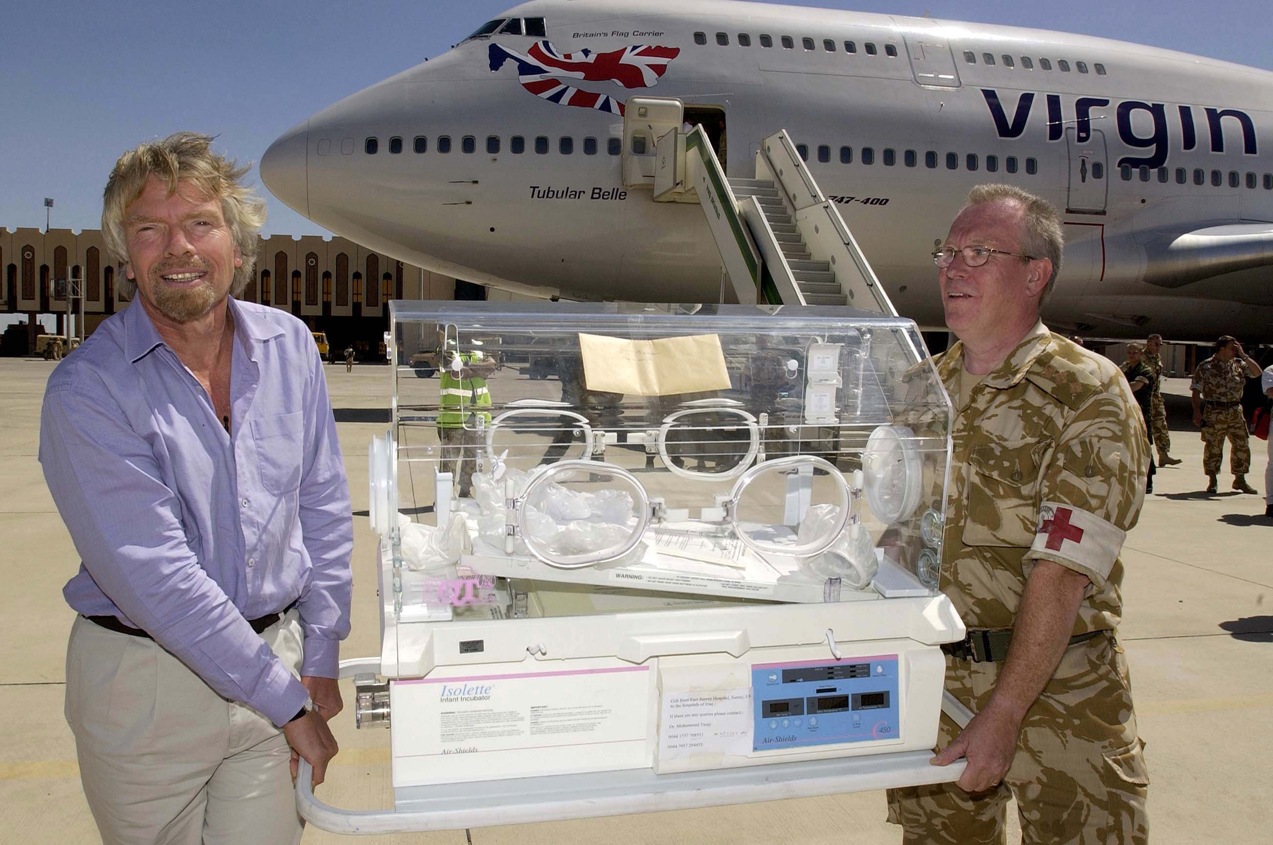 Richard Branson on the tarmac after his aid flight to Iraq with Virgin Atlantic