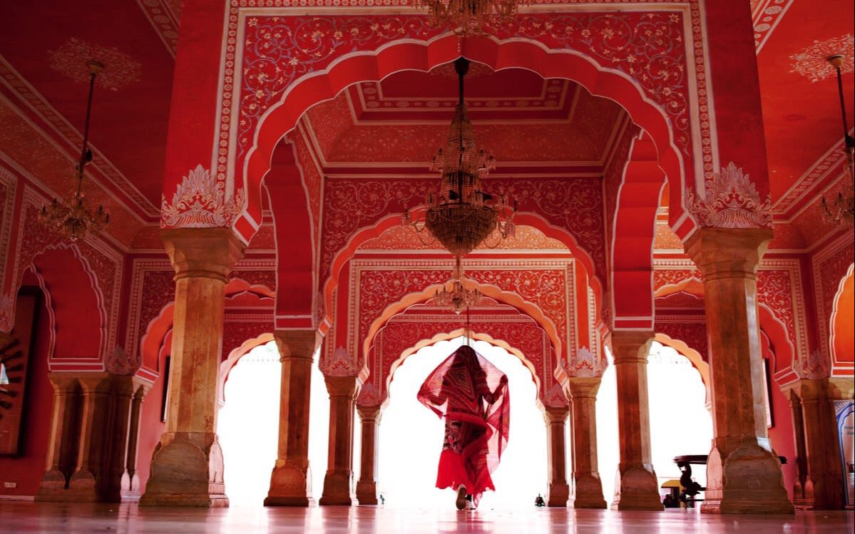 A woman dressed in red inside an Indian temple