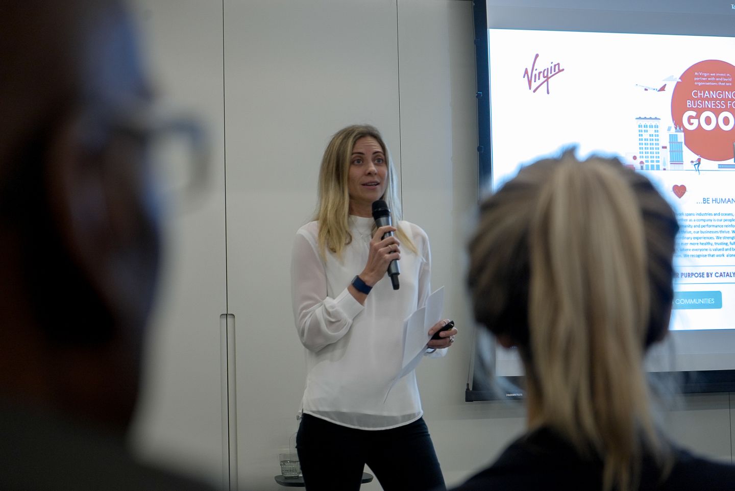 Holly Branson speaking at a townhall event for Virgin Management and Virgin Red