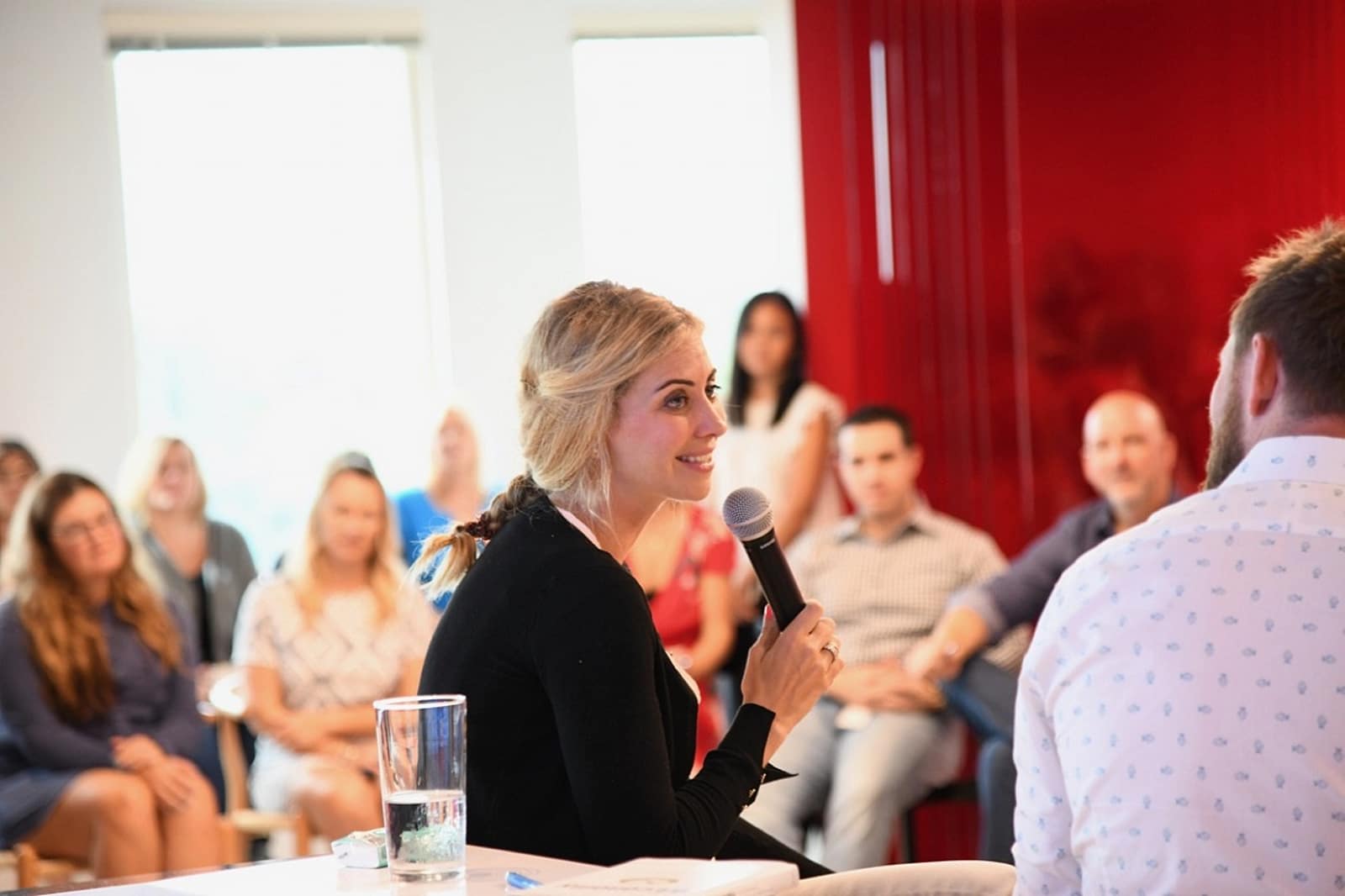 Holly Branson speaking on a panel, with an audience in the background