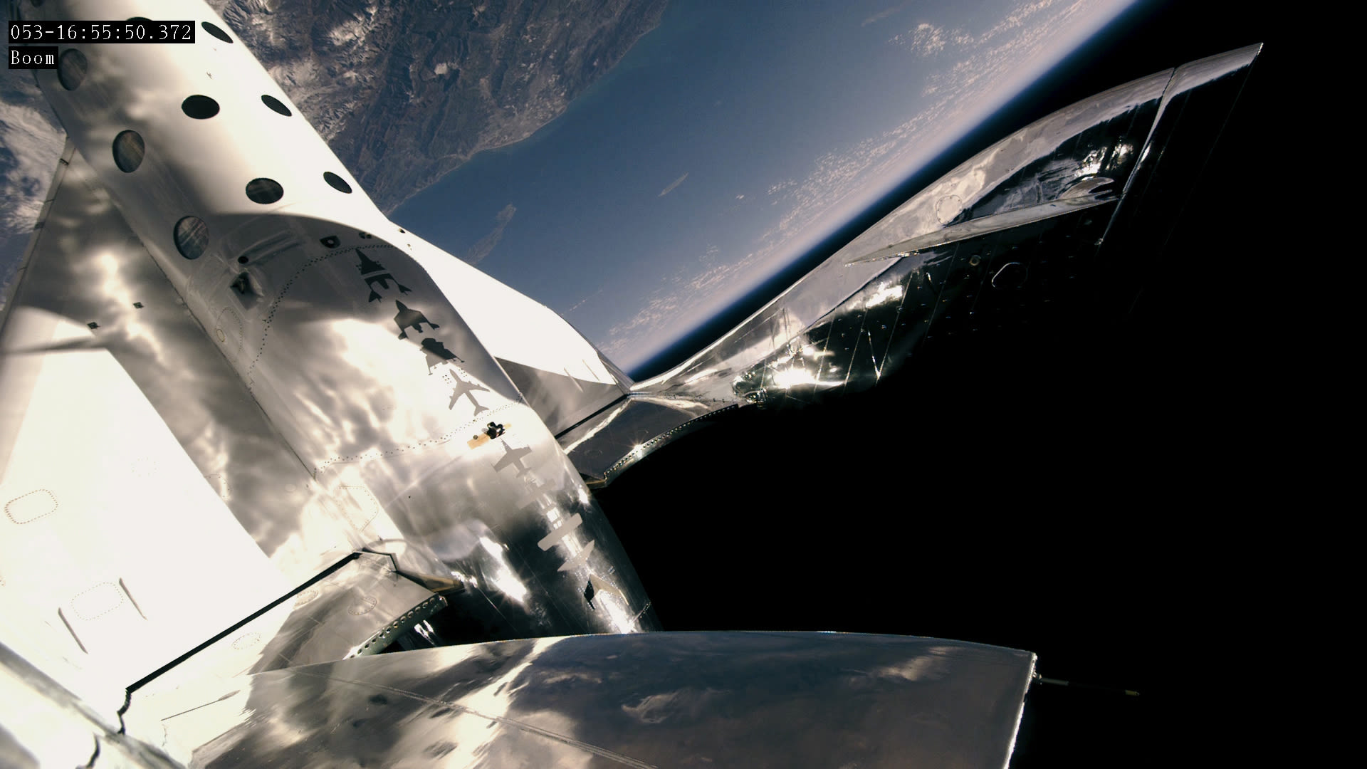 Virgin Galactic's SpaceShipTwo flying above Earth
