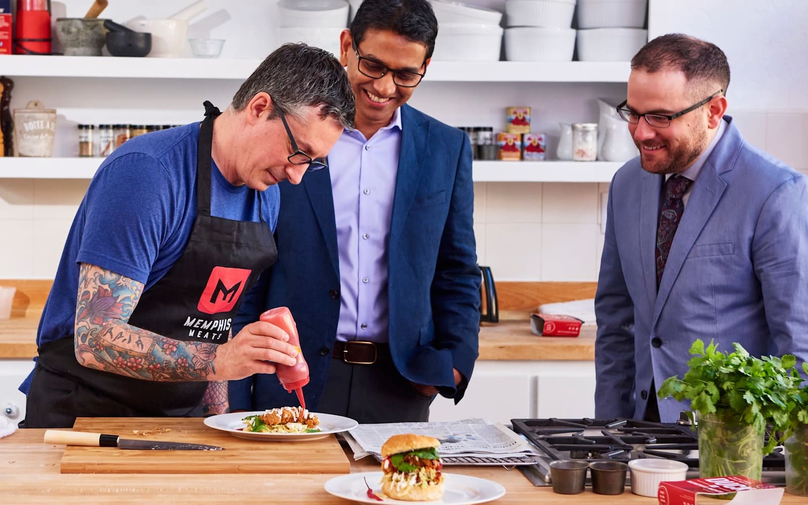 Uma Valeti, CEO of Upside Foods, looks on as a chef prepares a meal