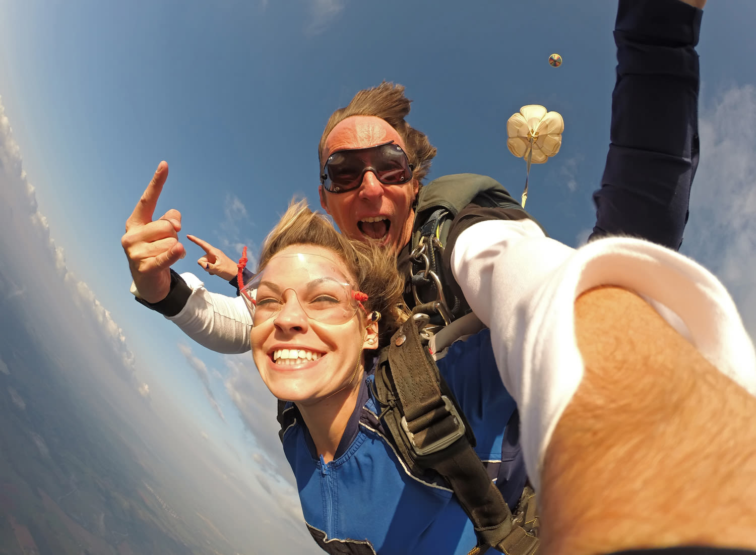 Two people taking a selfie during a tandem skydive