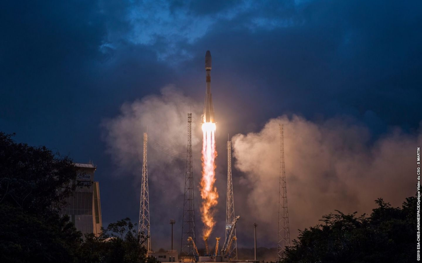 A rocket takes off at dusk