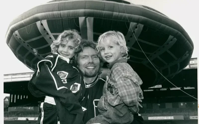 Richard holding Holly and Sam standing in front of the inflatable UFO 