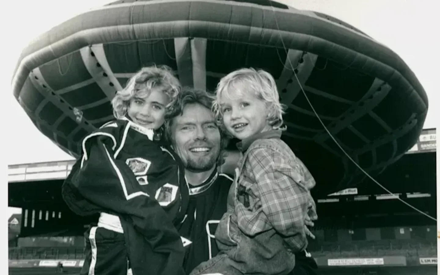 Richard Branson with Sam and Holly as children in front of a UFO
