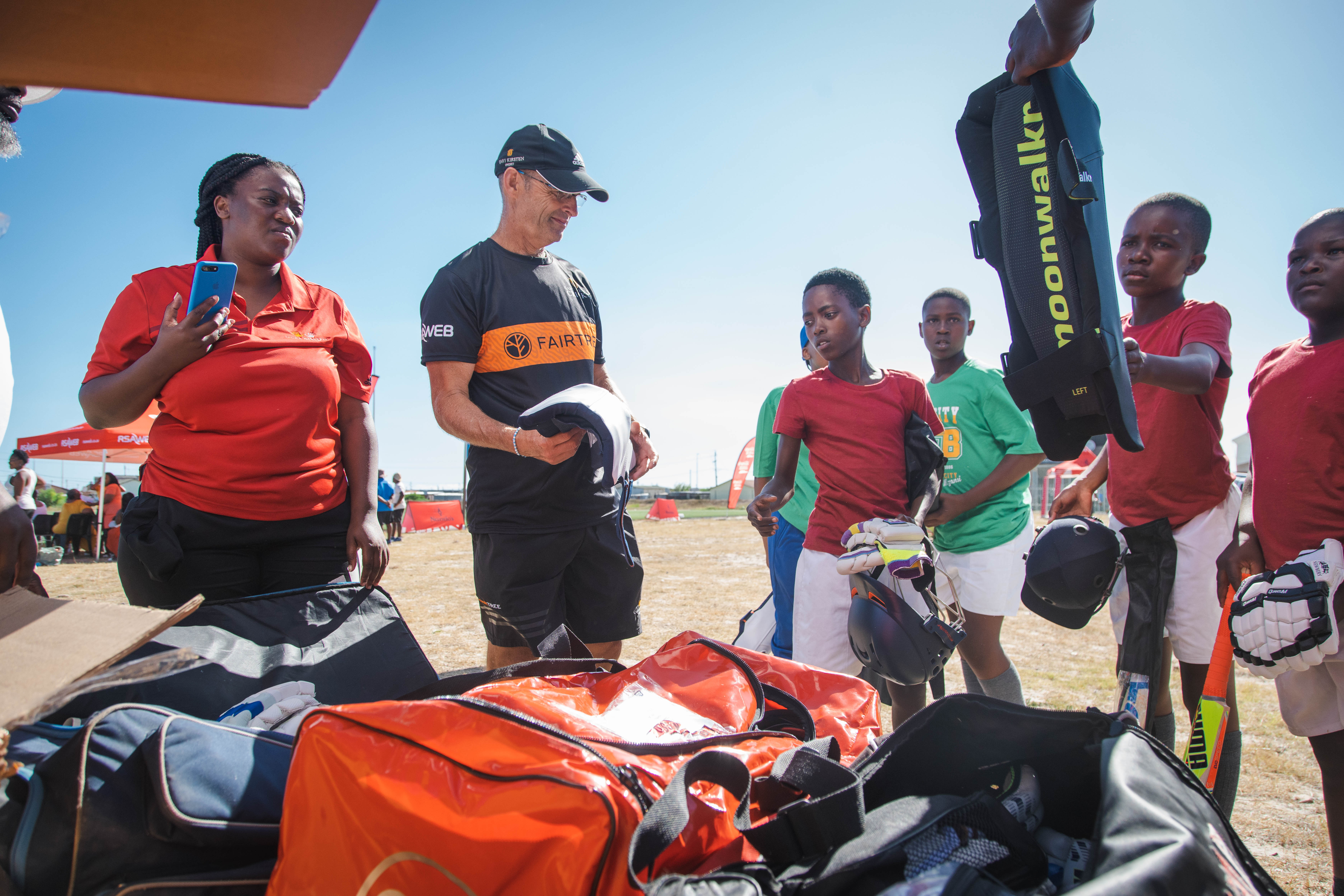 Children receiving cricket equipment in South Africa