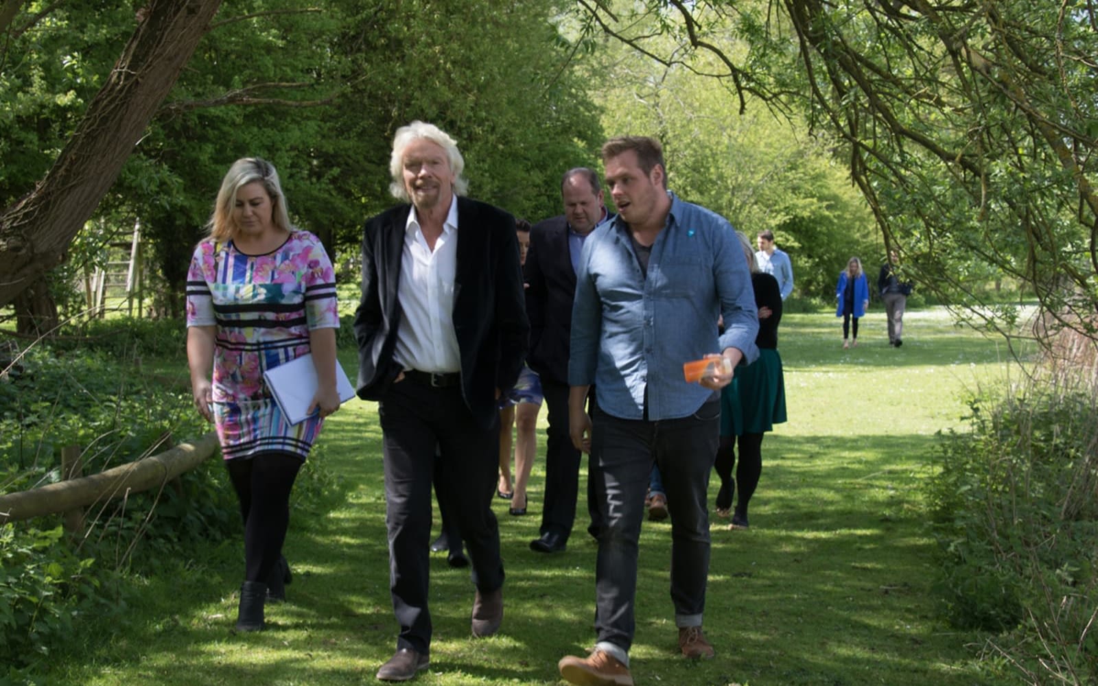 Richard Branson in a walking meeting with Virgin team members