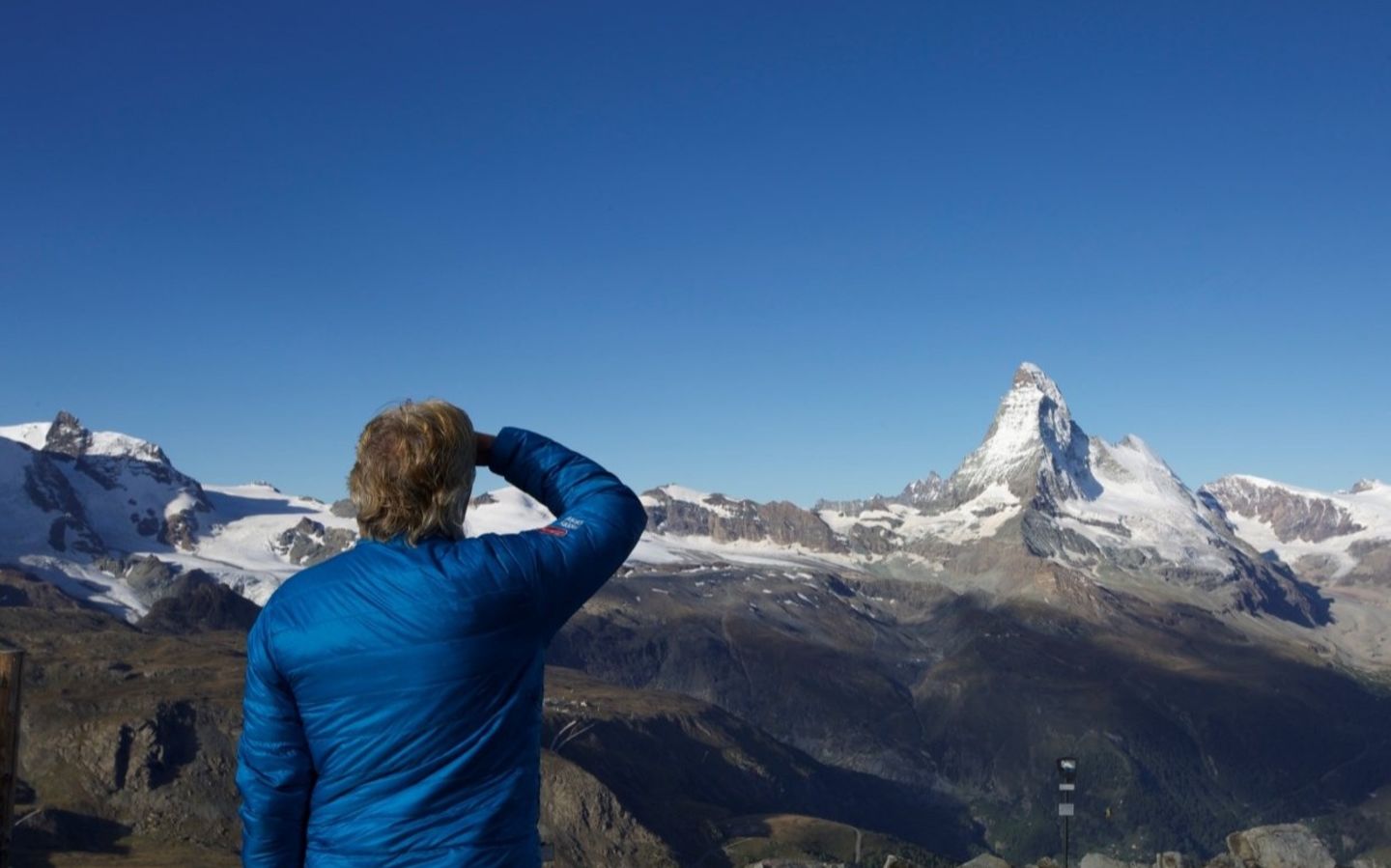 Richard turned around looking at a mountain in the distance