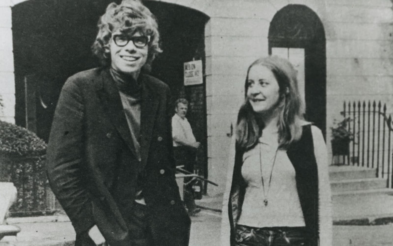 Black and white image of Richard Branson as a student standing next to a female student