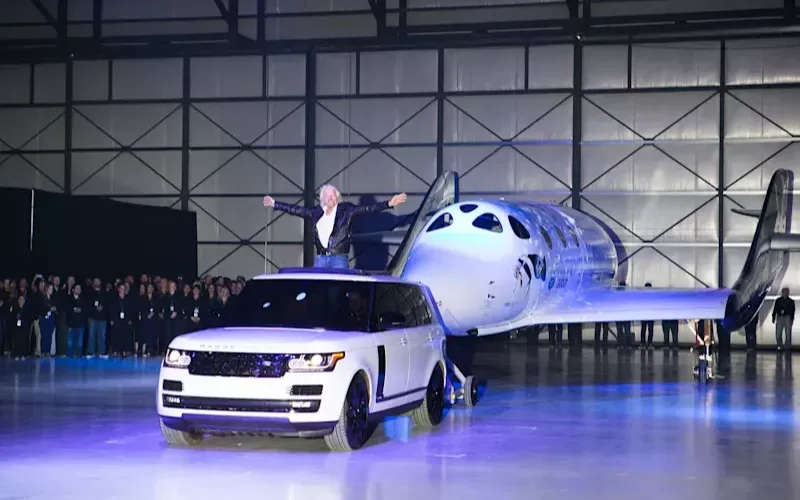 Richard Branson in a white Range Rover in front of VSS Unity