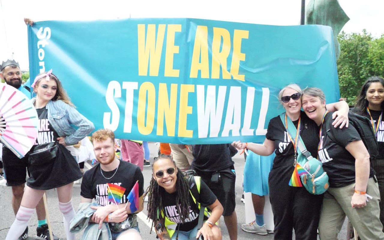 Image of a group of people holding up a banner that says "WE ARE STONEWALL".