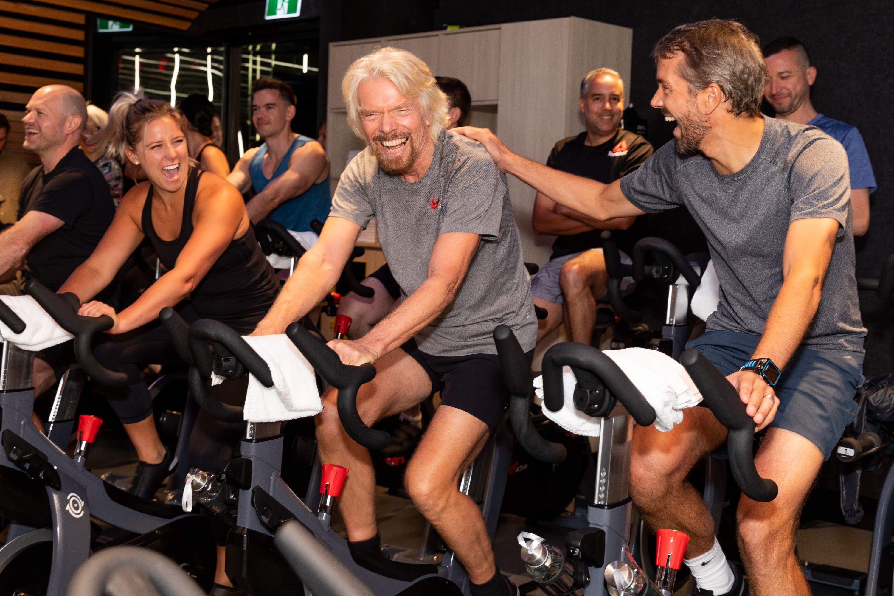 Josh Bayliss and Richard Branson take part in an indoor cycling class at Virgin Active