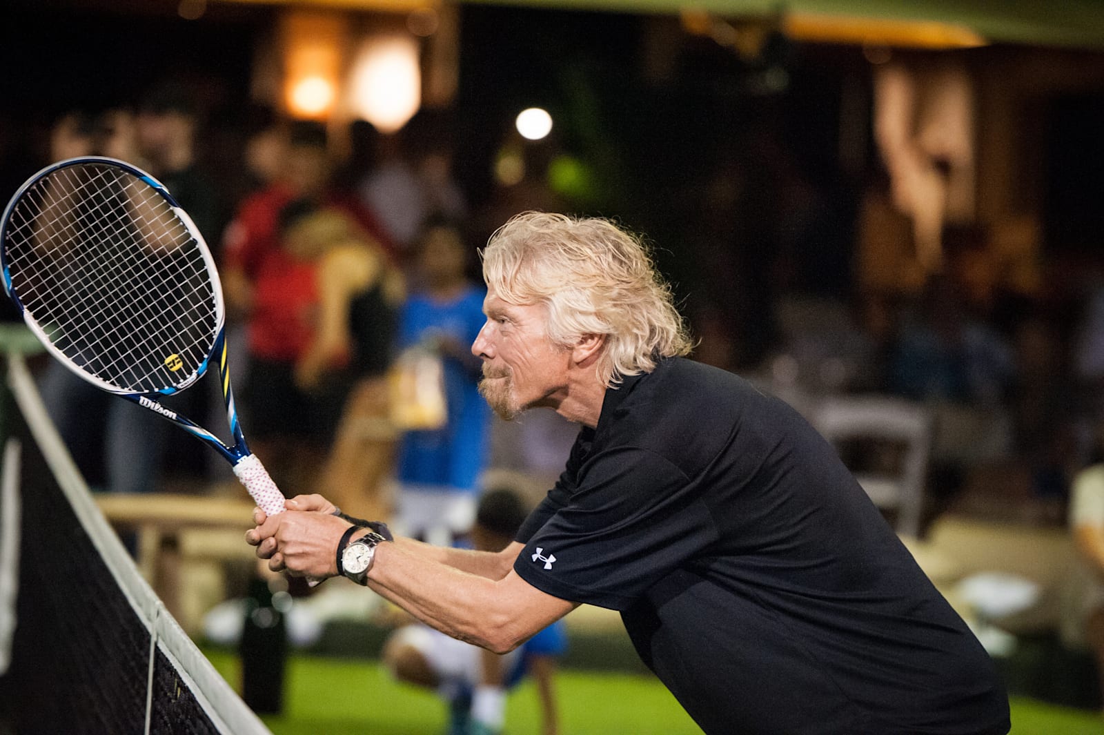 Richard Branson holding tennis racket