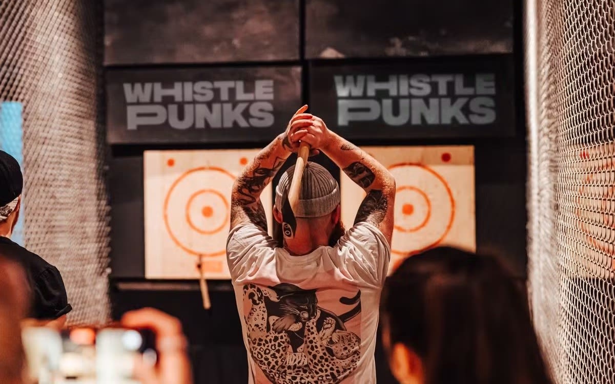 An image of someone axe throwing as Whistle Punks