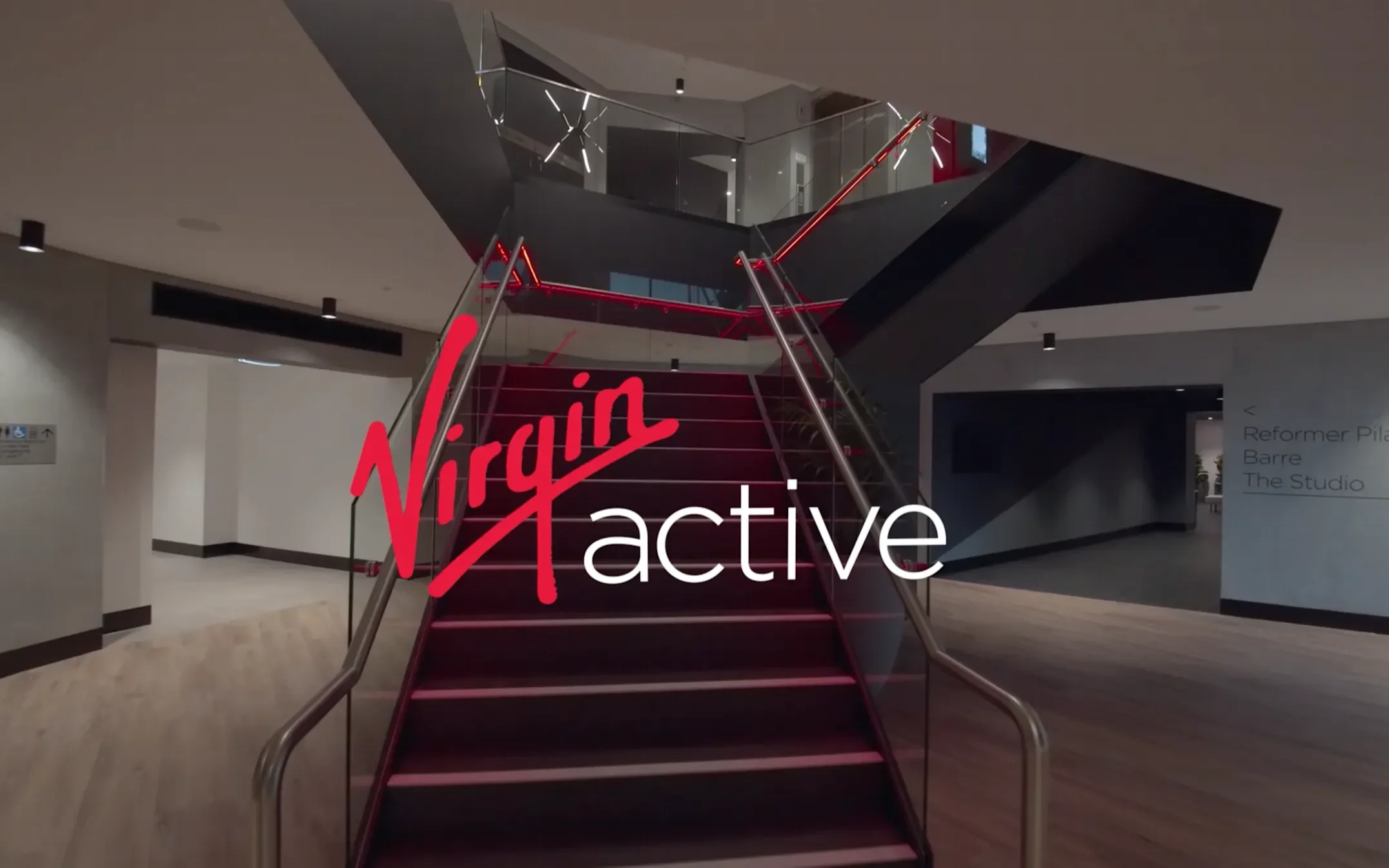 The Virgin Active logo over a picture of the entrance to Virgin Active Margaret Street