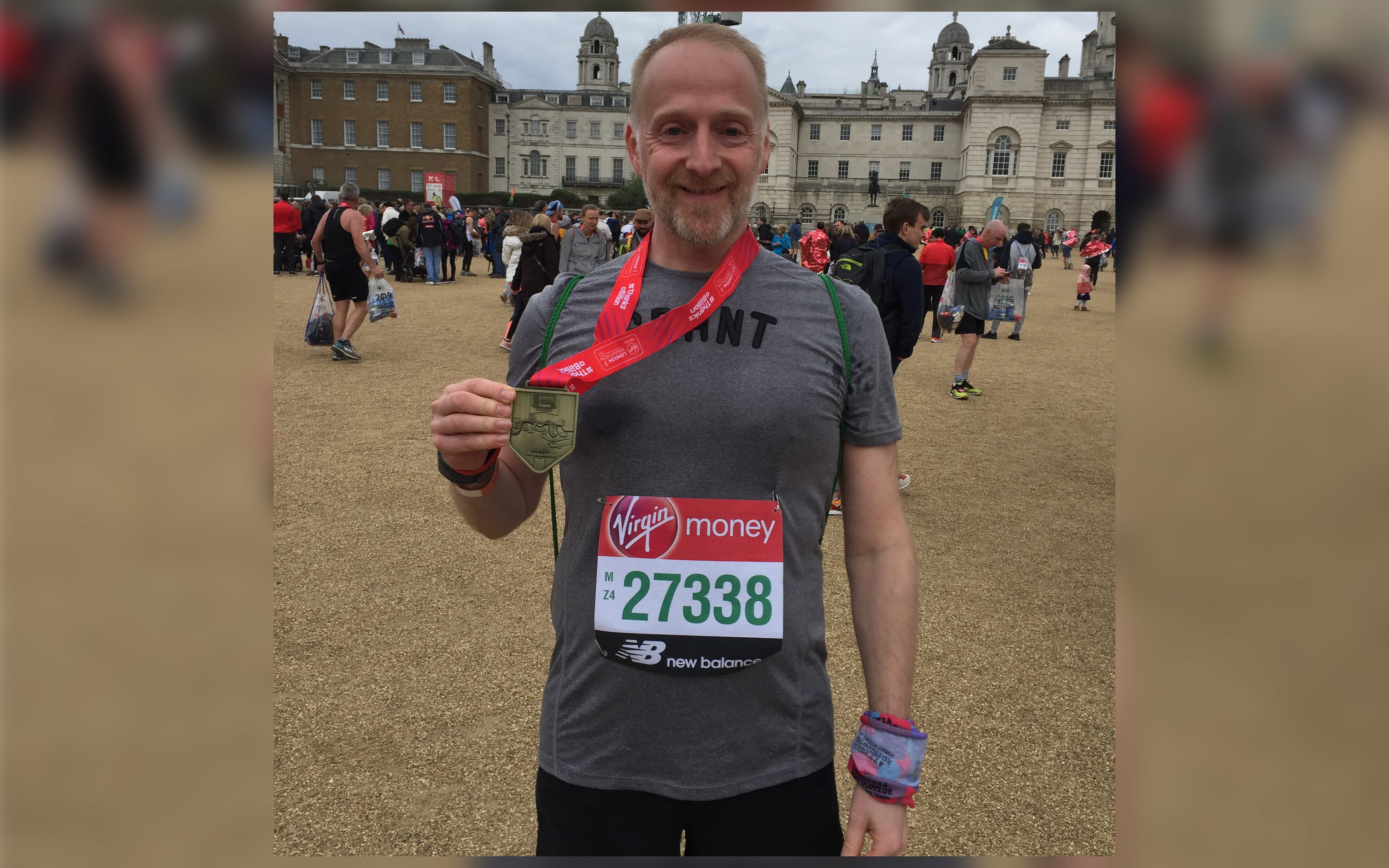 Grant Mackay holding his medal from the 2019 Virgin Money London Marathon