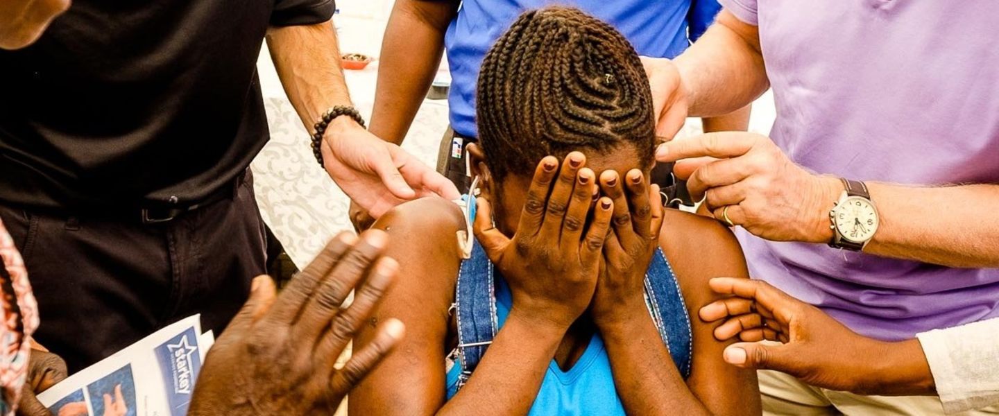 A young girl with her face in her palms 