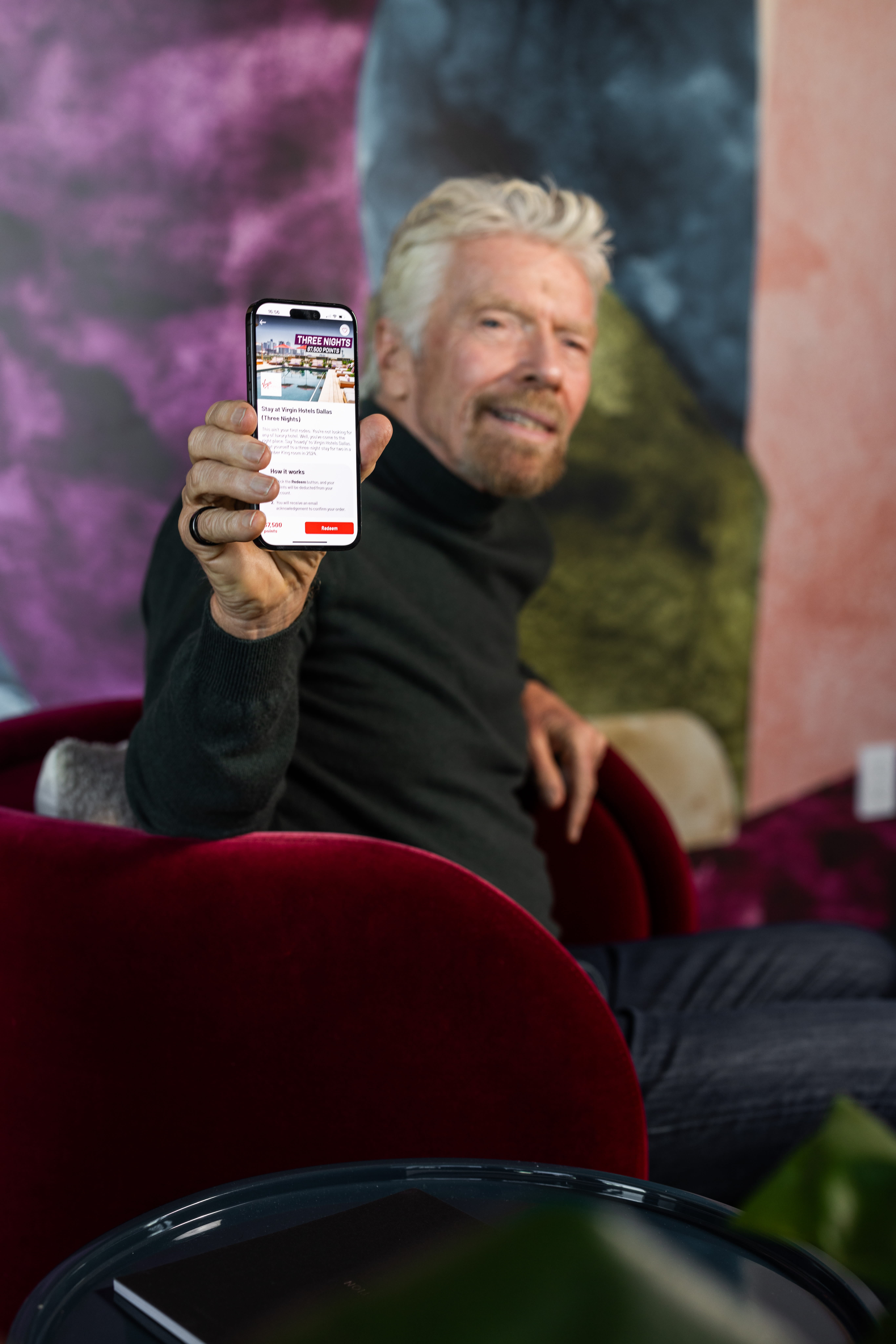 Richard Branson looking at the Virgin Red app