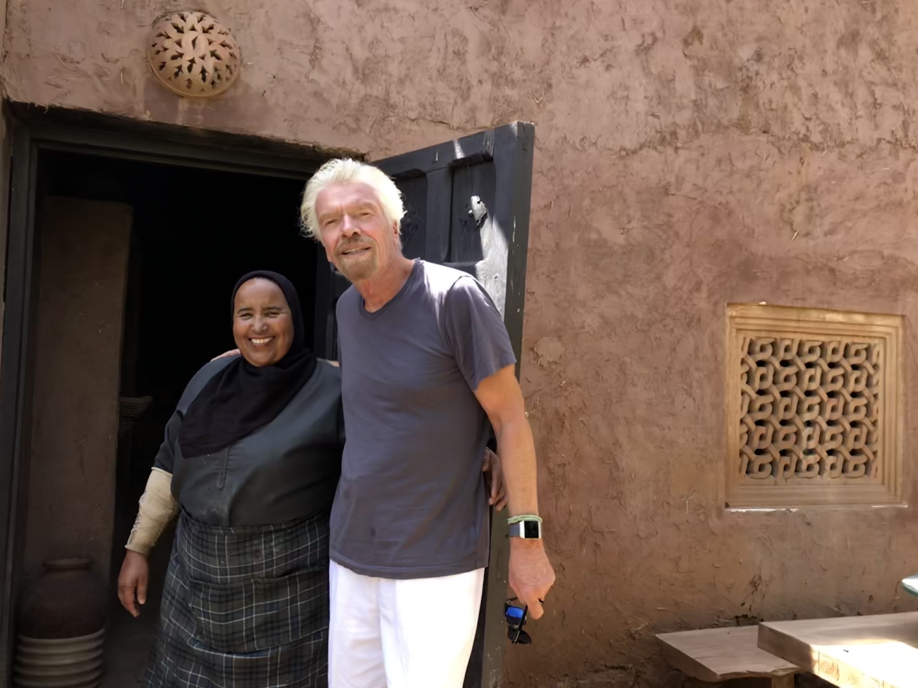 Richard Branson smiling with a lady outside Kasbah Tamadot