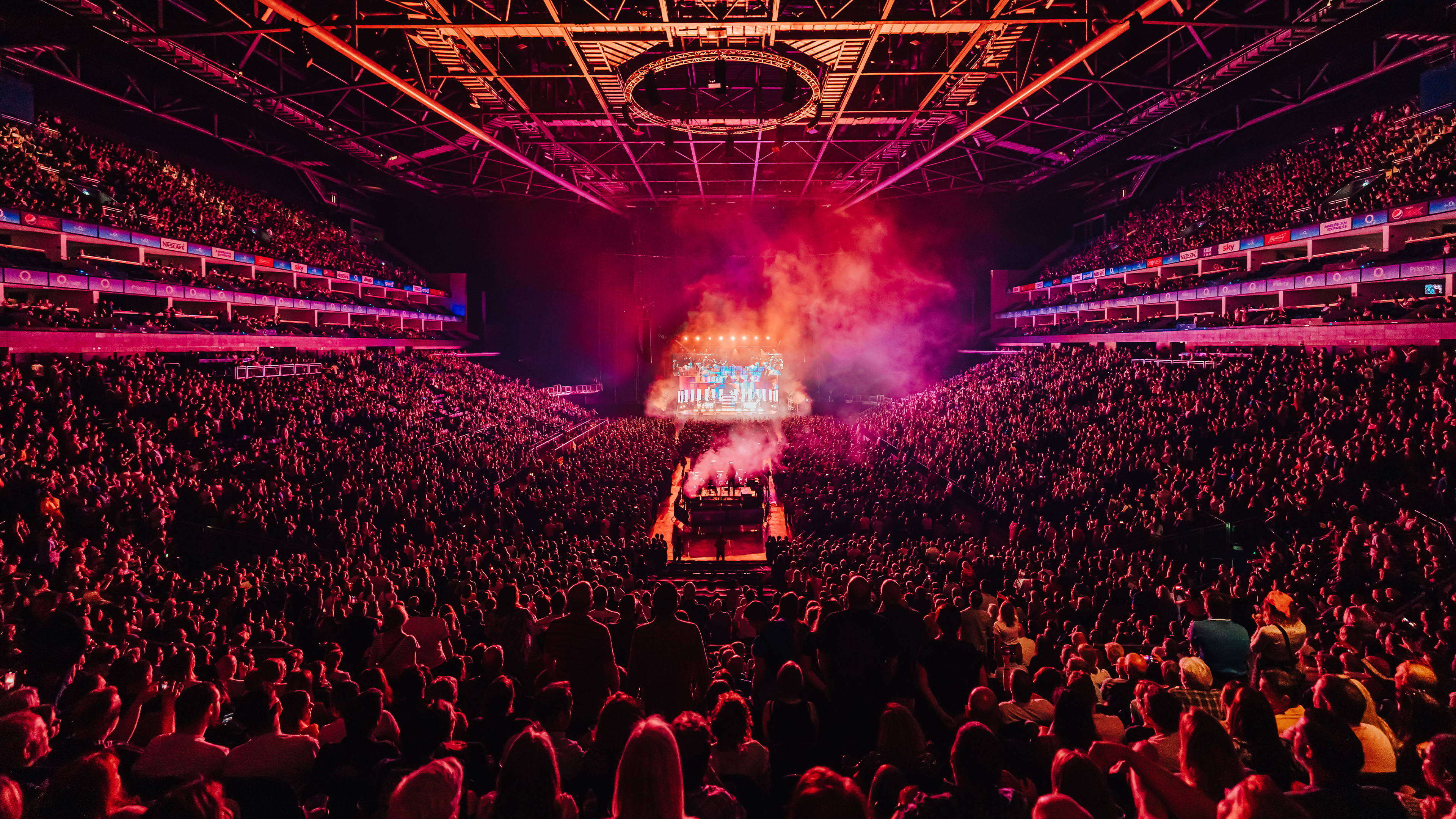 Image of stage at O2 arena lit up in red