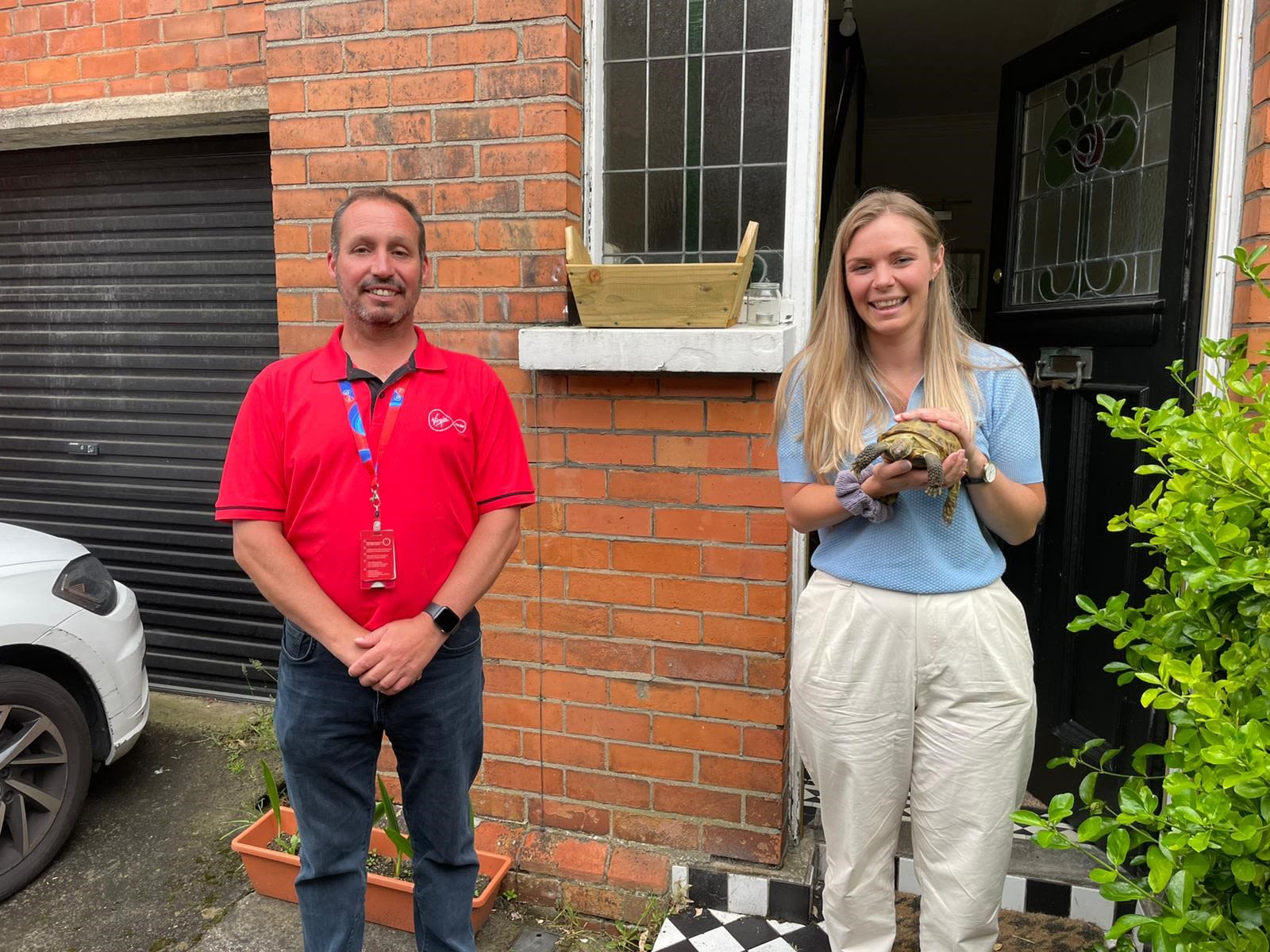 Hermes the tortoise with his owner Cedar and a Virgin Media engineer