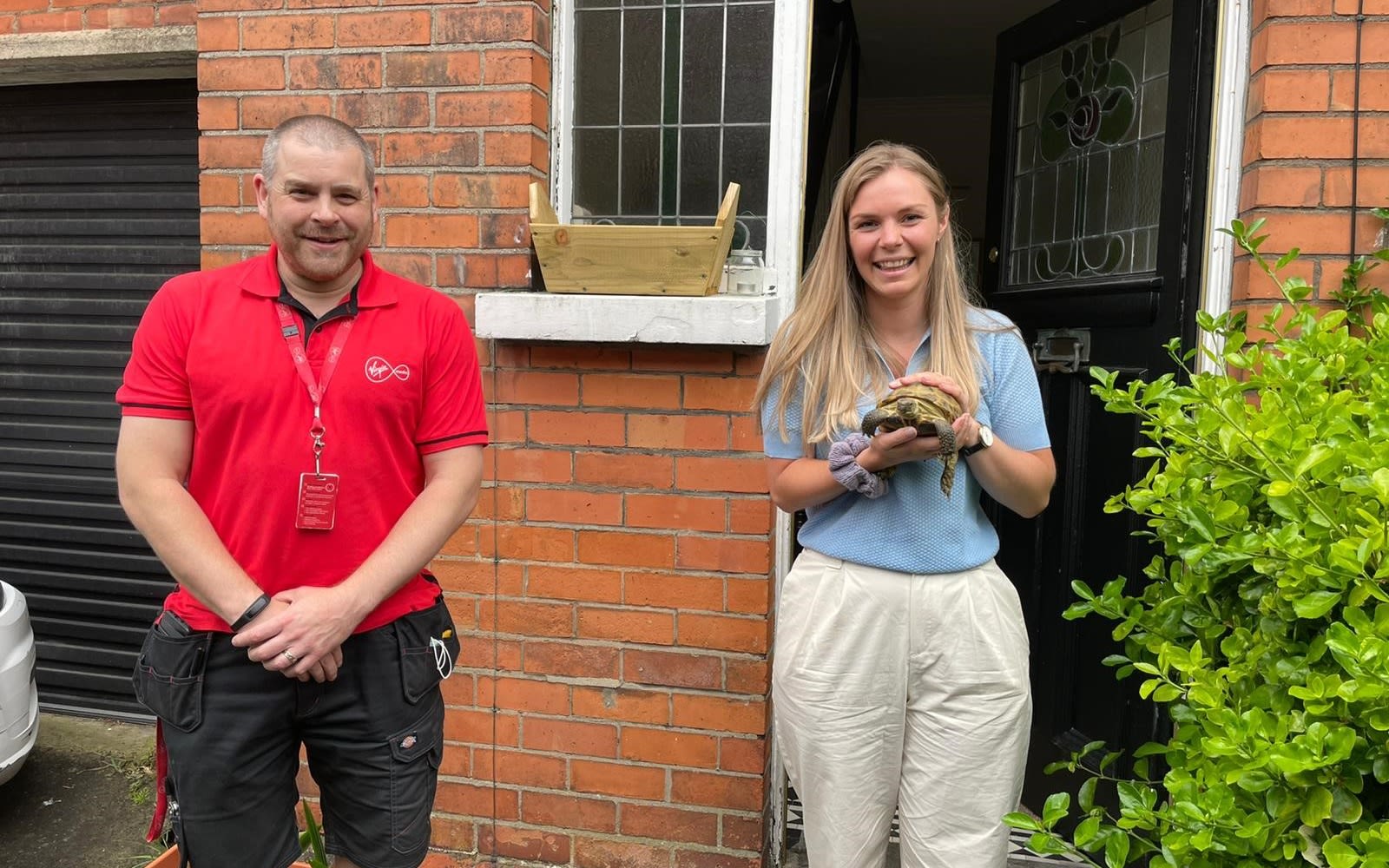 Hermes the tortoise with his owner Cedar and a Virgin Media engineer