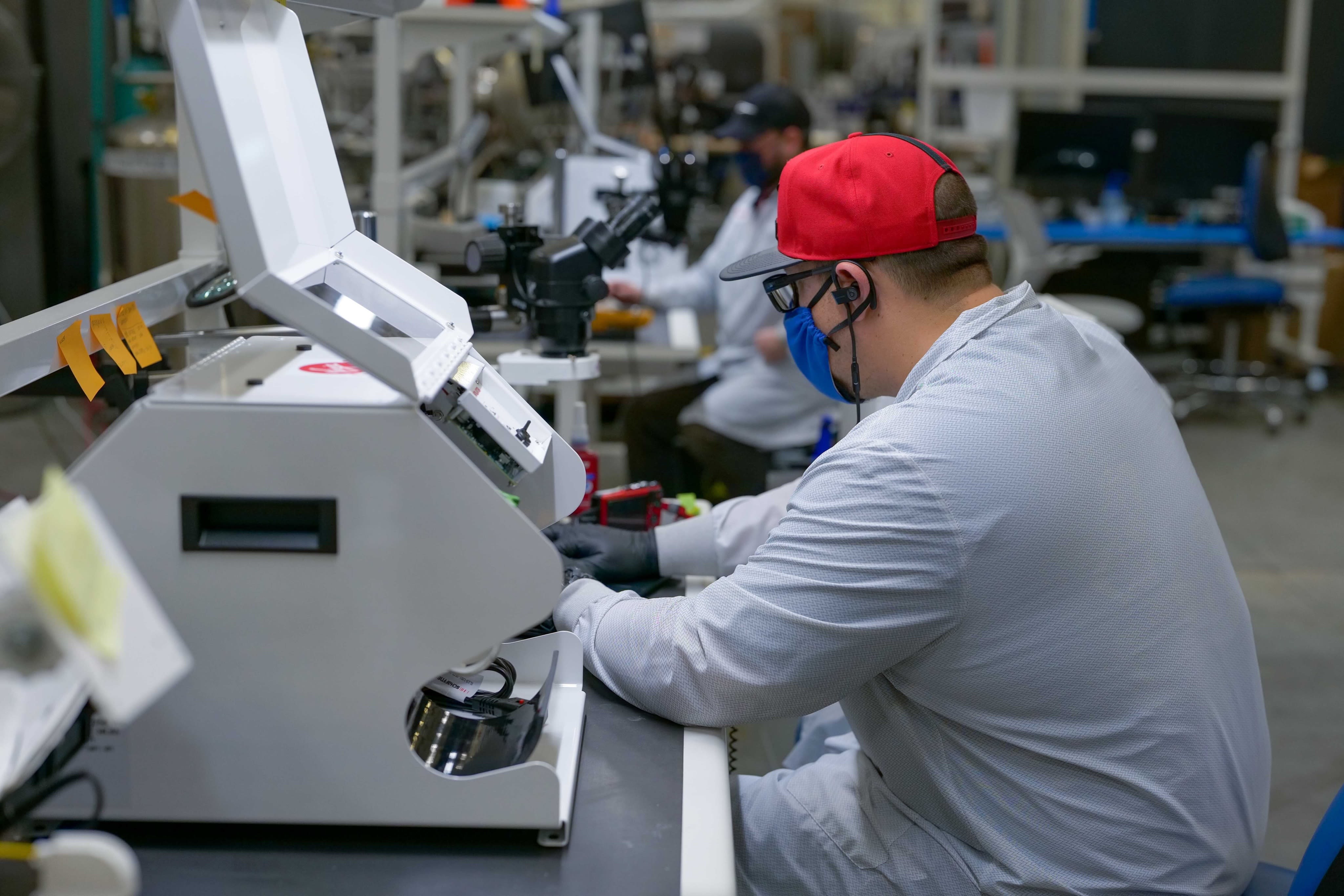 A Virgin Orbit engineer working on a ventilator