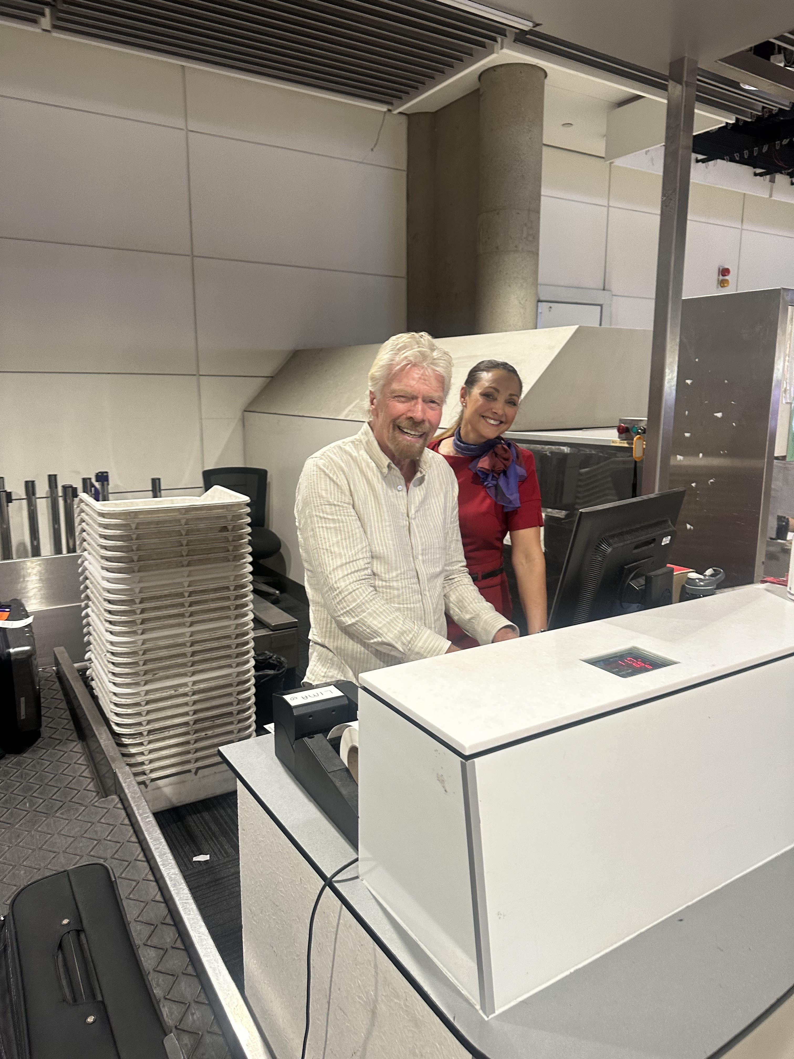 Richard Branson pretending to work at the Virgin Australia check-in desk