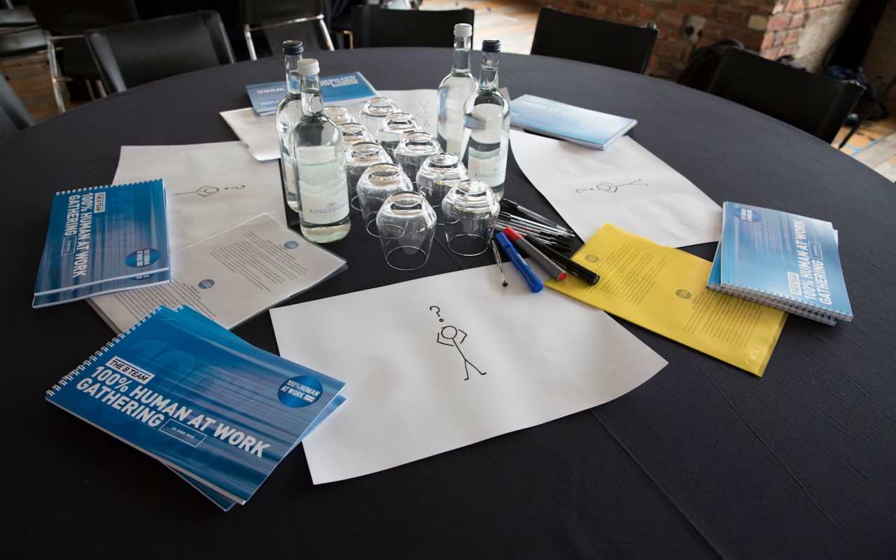 A table set up for a 100% Human at Work conference