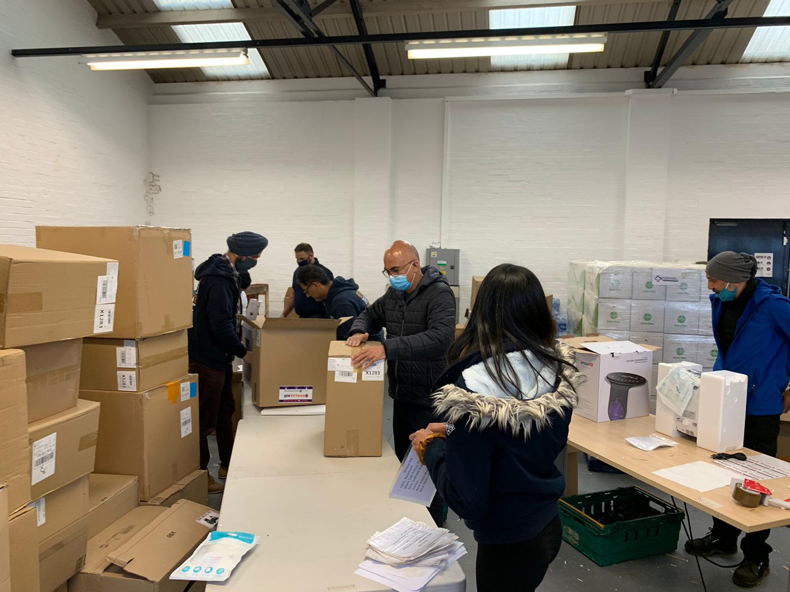 Khalsa Aid volunteers preparing boxes for the flight