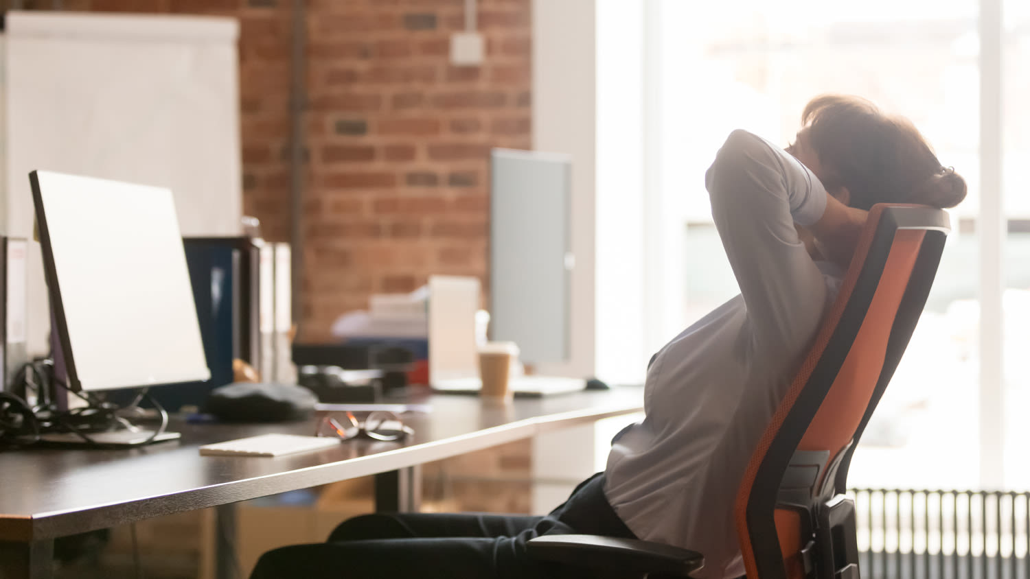 A woman leaning back in her office chair